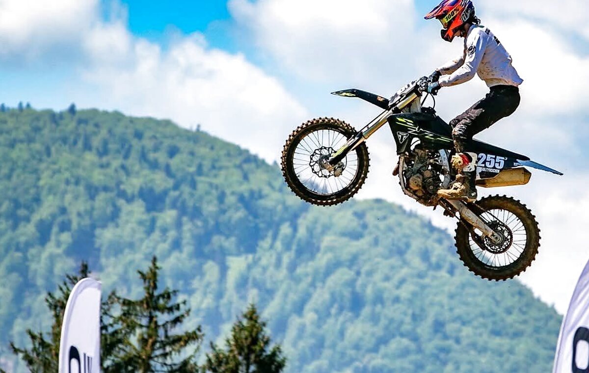 Motocross rider jumping at competition